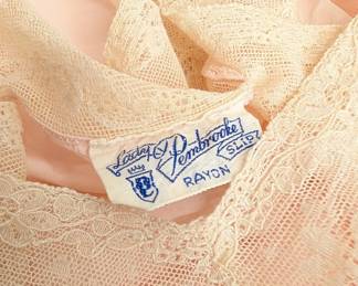 Closeup of vintage Lady Pembrooke peach color rayon and ecru lace slip