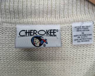 Closeup of the Cherokee men's vintage short-sleeve knit polo sweater featuring a Southwestern-style geometric pattern band at the waist, size M