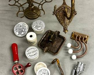 Antique items including ceramic advertising pot lids and jars from the Victorian era advertising cold cream and tooth paste from Boots Cash Chemist, a two piece figural head corkscrew and bottle opener, an "eggbeater" style hand crank mechanical drill, and more.  