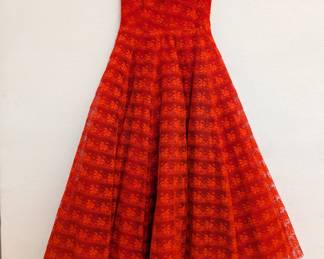 A vintage-style red strapless lace dress with a full skirt and sweetheart neckline