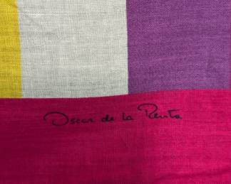 Closeup of vintage Oscar de la Renta silk scarf with graphic design of a woman against pink, red, and white stripes