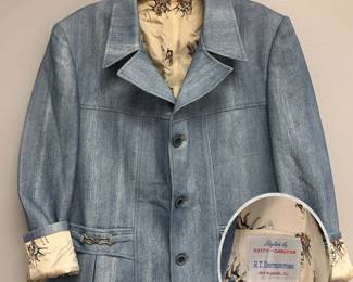 A vintage 1970s blue blazer/sport coat designed by Keith-Carlton, with a patterned polo player interior lining