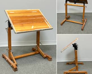A vintage mid-20th century drafting table featuring a solid wood top and an adjustable oak base. Top is 26"W x  20"D.