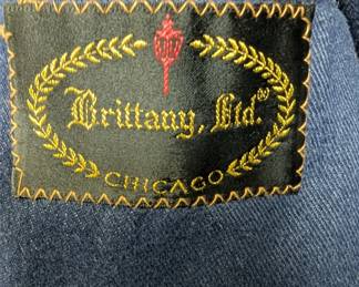 Closeup of the incredible 1970s men's denim three-piece suit with leather-covered buttons; inside label from Brittany Ltd. Chicago. You could land a plane on those lapels...