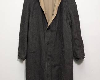 A vintage herringbone tweed overcoat, often styled as a balmacaan coat with raglan sleeves