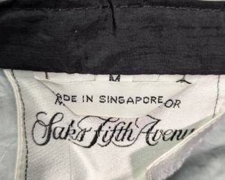 Closeup of tag inside the Saks Fifth Avenue hooded black windbreaker/rain jacket 