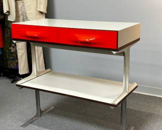 A Raymond Loewy DF2000 two-drawer mini-credenza console table (or stereo/tv table!), from the “DF2000” collection designed by legendary industrial designer Raymond Loewy and produced by Doubinsky Freres, 1968; the drawer fronts moulded from vivid red Metacrylene set in a frame of off-white plastic and rosewood veneer supported by moulded lacquered white aluminum. (Shown here with another spare stand or set of spare legs that was attached to a piece of matching laminate to create a coffee table)