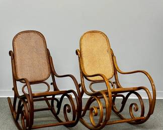 A pair of vintage Thonet-style bentwood rocking chairs with rattan backs and seats