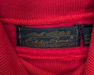 Closeup of Eddie Bauer red turtle neck sweatshirt with one zippered breast pocket
