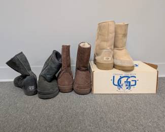 Three pair of men's UGG leather boots, in black, brown, and tan