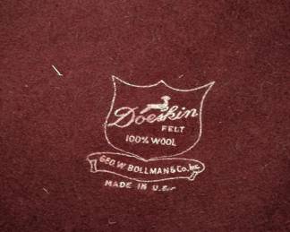 Closeup of vintage Doeskin Felt burgundy wool hat with wide brim and ribbon band