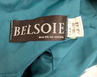 Closeup of beautiful Belsoie teal silk A-line formal dress with a V-neck and a rhinestone buckle at the shirred waist, size 16