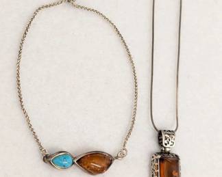 A sterling silver choker necklace with bezel-set amber and turquoise, and a sterling silver and amber pendant necklace