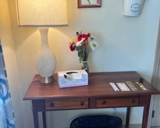 Solid cherry wood two-drawer writing desk, and a textured white lamp