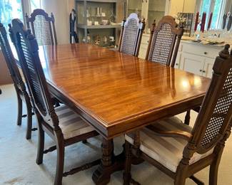 Thomasville wood dining table and set of 8 high-back cane chairs (comes with additional leaf)