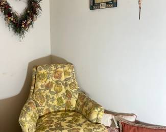 Traditional high-back wing chair featuring a colorful garden floral pattern and tufted back