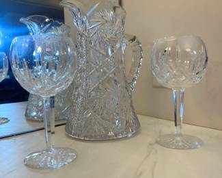 Heavy-cut crystal pitcher and matching diamond-cut wine goblets