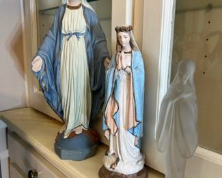 Madonna figures, including a large hand-painted statue and a sleek frosted glass bust
