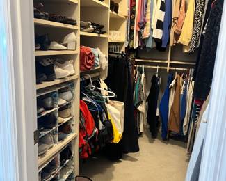 Extensive wardrobe featuring designer labels, professional blazers, casual wear, and a large shoe collection. Women's shoe sizes 10-11