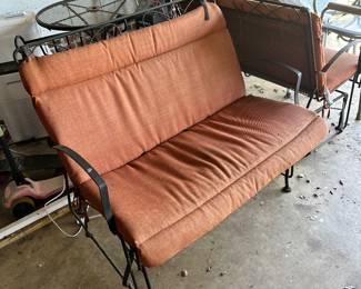 Wrought iron glider with cushion