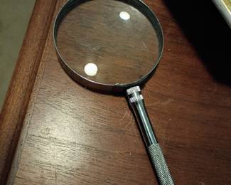 Vintage magnifying glass with metal handle