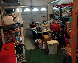 Packed garage with tools, memorabilia, and seasonal items