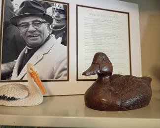 Framed Vince Lombardi photo, pelican figurine, wooden duck decoy