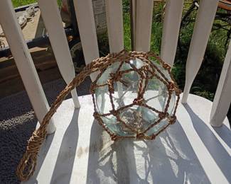Vintage glass fishing float with rope netting, nautical decor