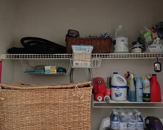 Laundry room with wicker hamper and cleaning supplies