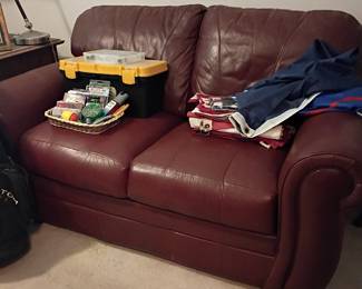 Burgundy leather loveseat with sewing kit