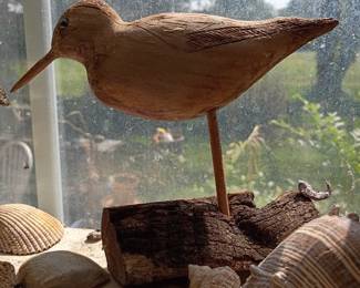 Hand-carved wood shorebird sculpture with shells