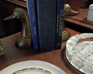 Brass duck bookends with hardcover books