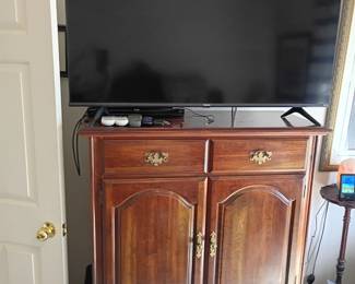 Wood armoire with flat-screen TV on top