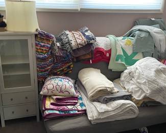 Linens, flags, futon, cabinet