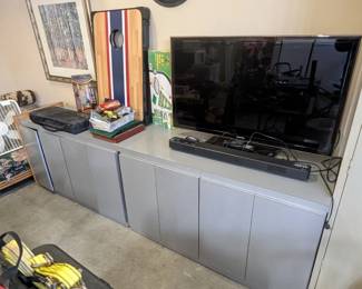 Multiple garage storage cabinets, sound bar and 48" tv
