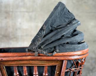 This lot features a beautiful antique Victorian-style doll carriage made from wicker, wood, and metal. This piece measures, 17.5” H x 19” W x 7” D.