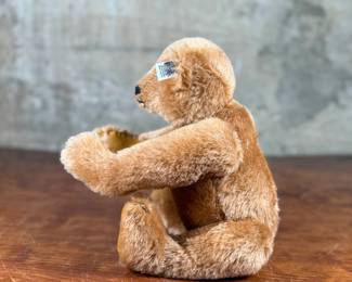 Steiff original teddy bear featuring brown mohair fur and a classic black stitched nose. Retains the trademark Steiff tag in the ear and button. In good condition with visible iconic craftsmanship.