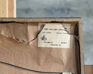 Framed posters advertising the Buffalo Ranch Real Wild West show. Printed by Riverside Print Co., Chicago, these posters feature vibrant depictions of cowboys, Native Americans, and historical scenes. The frames show some age-related wear, and the paper backing is partially torn, exposing an art gallery label from Hulmeville, Pennsylvania. One of them is protected by glass and the other is not. Each one measures in frame, 37” H x 14.5” W.