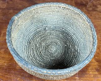 This lot features a turn of the century basket made of cedar root from the Cascades Plateau region, likely from the late 19th century or early 20th century. Measures, 3.5” H x 10” W x 10” D.