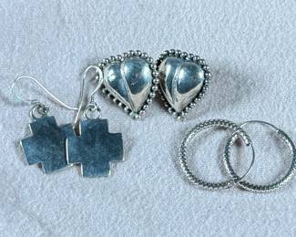 This lot features three (3) pairs of sterling silver earrings with a total approx. weight of 15.29 grams.