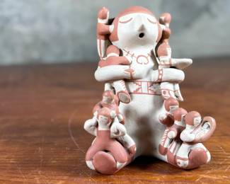 This lot features an original sculpture by listed Pueblo artist, Lupe Lucero Loretto. Signed underneath and measures, 5.25” H.