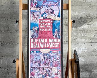 Framed posters advertising the Buffalo Ranch Real Wild West show. Printed by Riverside Print Co., Chicago, these posters feature vibrant depictions of cowboys, Native Americans, and historical scenes. The frames show some age-related wear, and the paper backing is partially torn, exposing an art gallery label from Hulmeville, Pennsylvania. One of them is protected by glass and the other is not. Each one measures in frame, 37” H x 14.5” W.