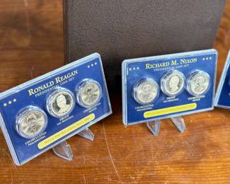 Complete 2007-2016 Presidential Dollar PDS 117-coin set featuring both brilliant uncirculated and proof coins. Coins are arranged in a dedicated album, with additional display cases for select presidential sets, including Richard Nixon, Gerald Ford, and Ronald Reagan. Includes original invoice indicating the purchase price of $339. Some missing as shown in photos.