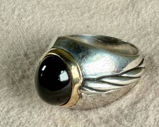 This lot features a ring made from 14k gold and sterling silver with an onyx center stone. This ring comes in a size 9.5 with a total approx. weight of 13.61 grams.