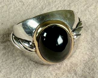 This lot features a ring made from 14k gold and sterling silver with an onyx center stone. This ring comes in a size 9.5 with a total approx. weight of 13.61 grams.