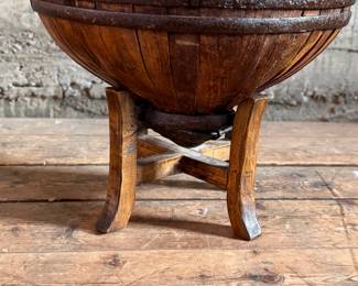 An antique Chinese wooden water bucket with stand. Features incredible patina through and well made. Measures on stand, 24” H x 18” W x 18” D.