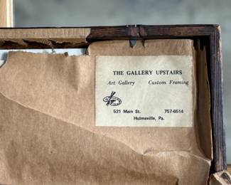 Framed posters advertising the Buffalo Ranch Real Wild West show. Printed by Riverside Print Co., Chicago, these posters feature vibrant depictions of cowboys, Native Americans, and historical scenes. The frames show some age-related wear, and the paper backing is partially torn, exposing an art gallery label from Hulmeville, Pennsylvania. One of them is protected by glass and the other is not. Each one measures in frame, 37” H x 14.5” W.