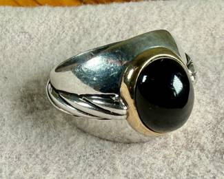 This lot features a ring made from 14k gold and sterling silver with an onyx center stone. This ring comes in a size 9.5 with a total approx. weight of 13.61 grams.