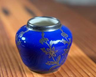 Johann Haviland Bavaria porcelain vase featuring a cobalt blue glaze with gilt floral design and sterling silver accents/rim. Bottom stamp reads “Johann Haviland Bavaria.” Measures 2” H, suitable as a small decorative piece or bud vase. Good condition with no visible cracks or chips.