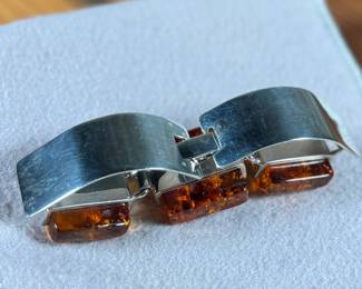 This lot features a stunning sterling silver & baltic amber bracelet that measures, 7” with a total approx. weight of 61.80 grams.